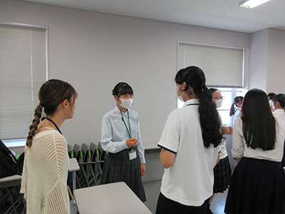 県立女子大学学生チューターのサポートを受けながら英語の活動をする塾生の様子